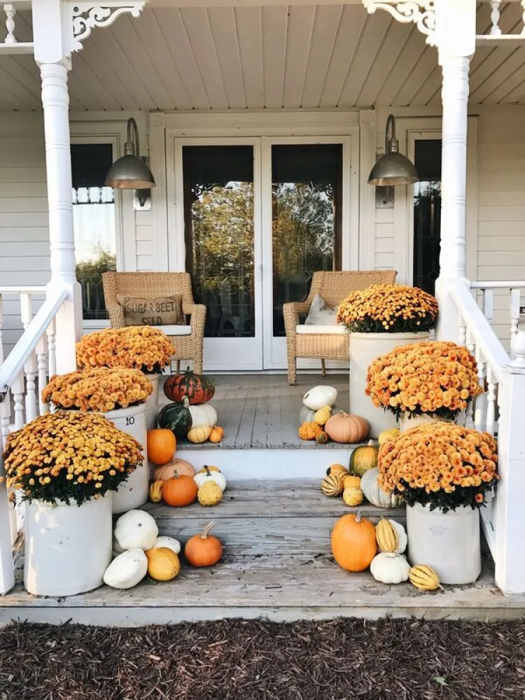 Seasonal porch styling with autumn greenery and decor