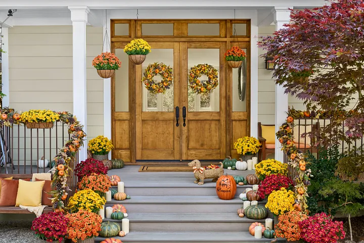 Autumn foliage and mums arranged at a porch entry